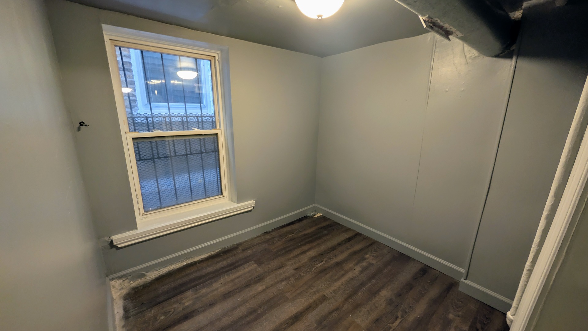 1629 West Beach Avenue, Unit 1F Chicago, IL 60622 - Photo 5 of 7 a view of an empty room and wooden floor