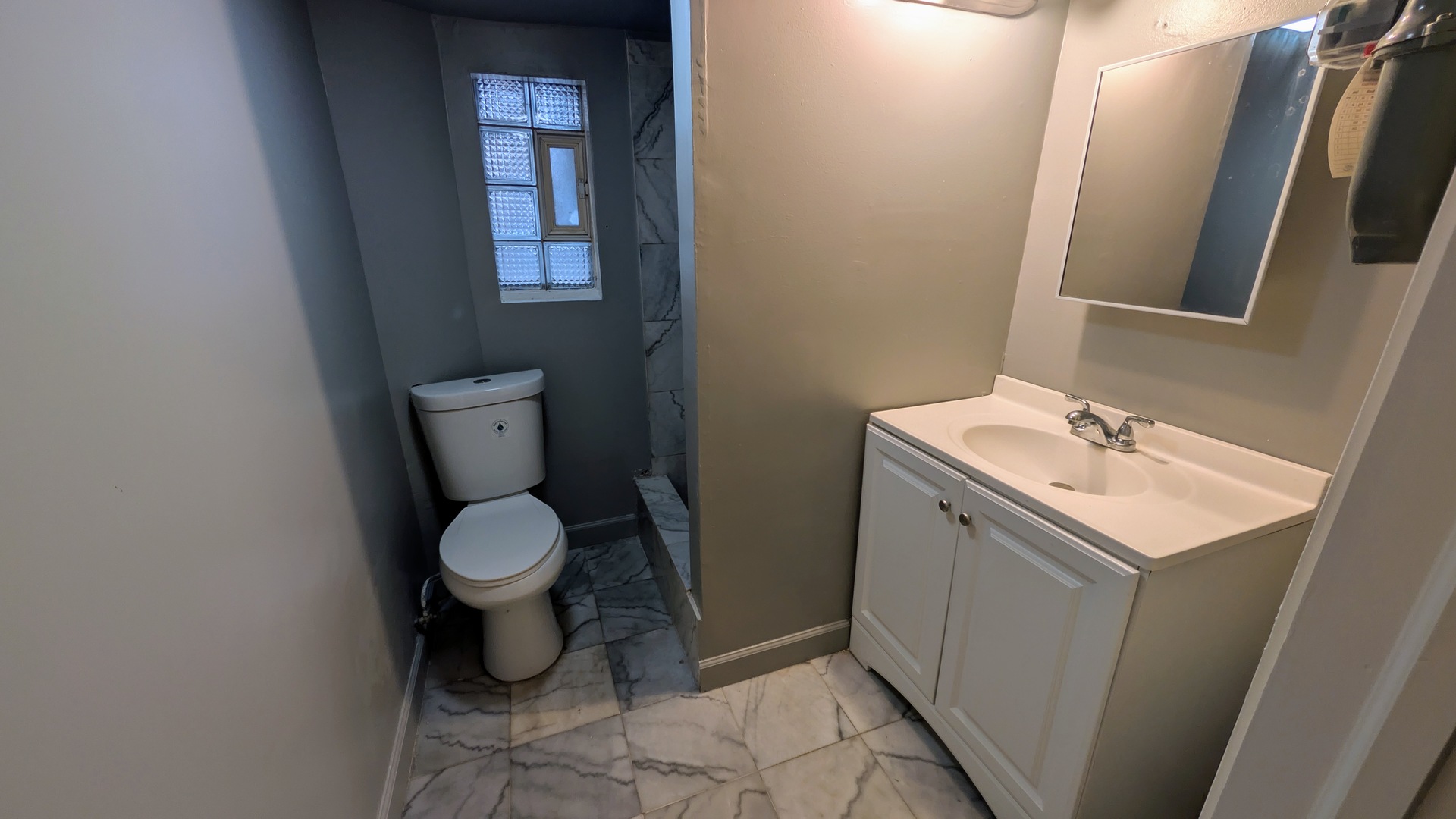1629 West Beach Avenue, Unit 1F Chicago, IL 60622 - Photo 6 of 7 a bathroom with a toilet sink and mirror