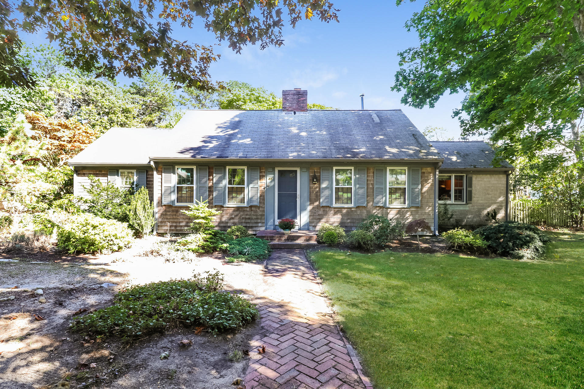 a front view of a house with a garden and porch