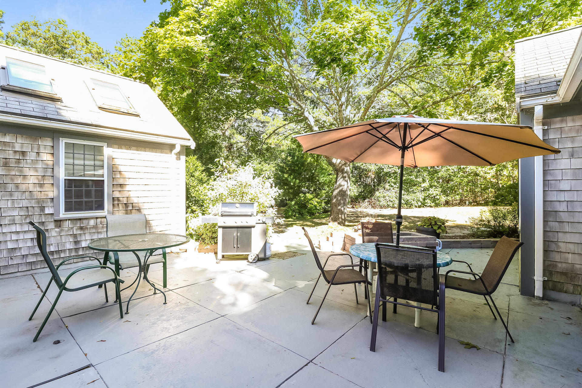 45 Brooks Road Harwich Port, MA 02646 - Photo 28 of 34 a view of wooden bench and chairs under an umbrella