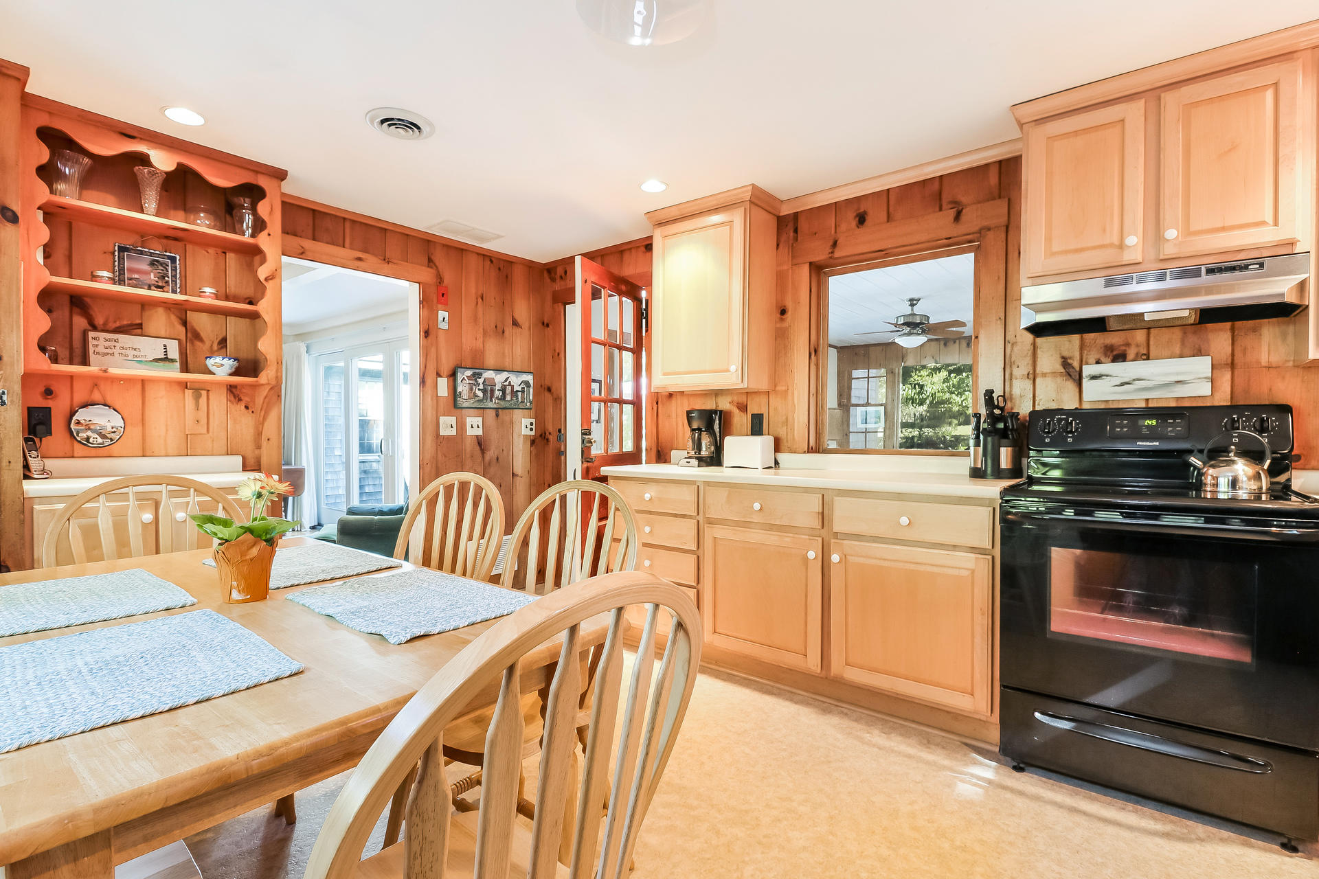 45 Brooks Road Harwich Port, MA 02646 - Photo 8 of 34 a kitchen with stainless steel appliances kitchen island granite countertop a stove a sink a dining table and chairs with wooden floor