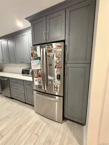 a kitchen with stainless steel appliances granite countertop a refrigerator and a sink