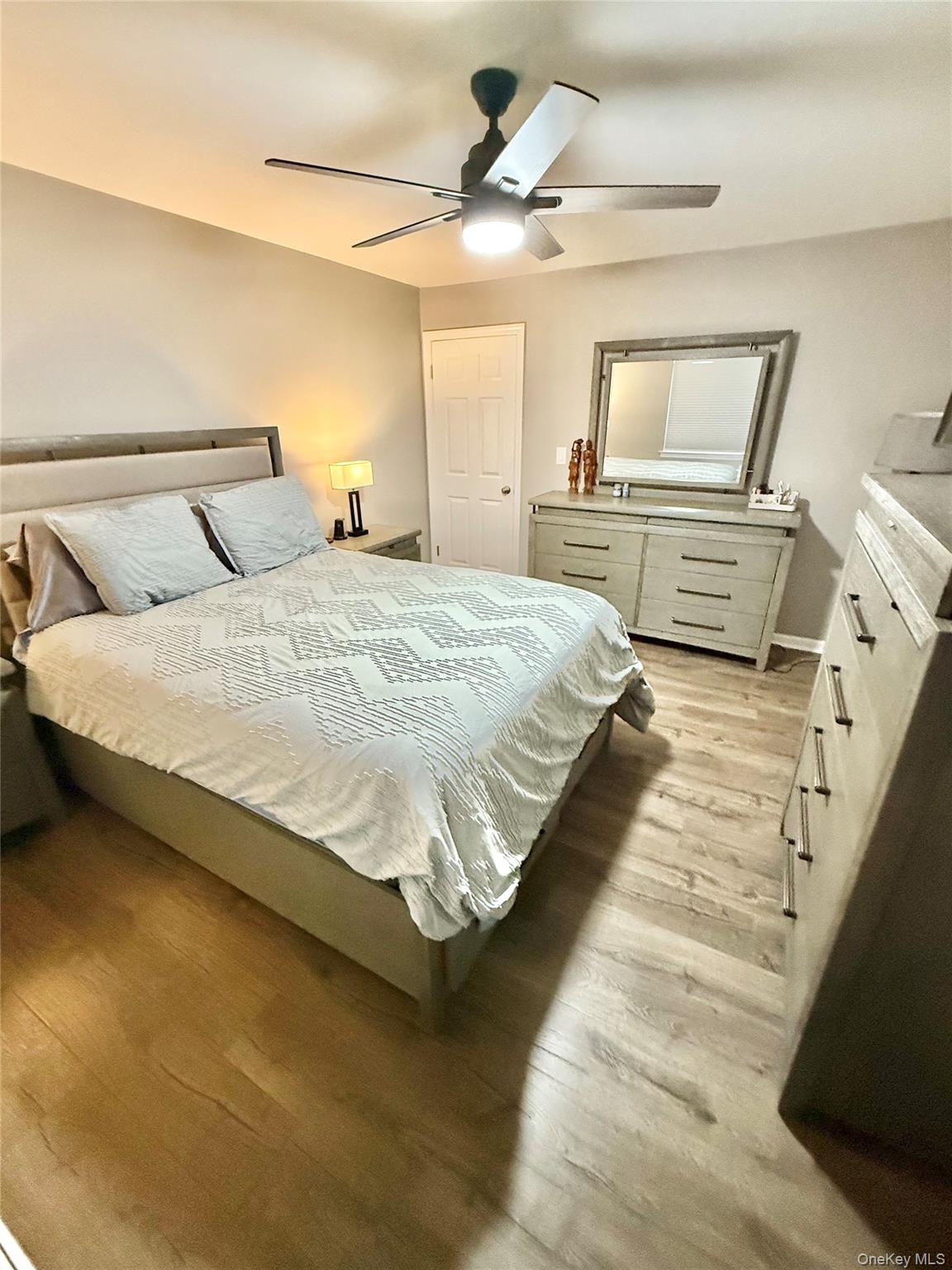 42 Briar Cliff, Unit 4 2 Ossining, NY 10562 - Photo 9 of 22 a bedroom with bed and a chandelier