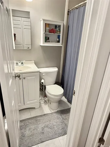 a bathroom with a toilet a sink and a mirror