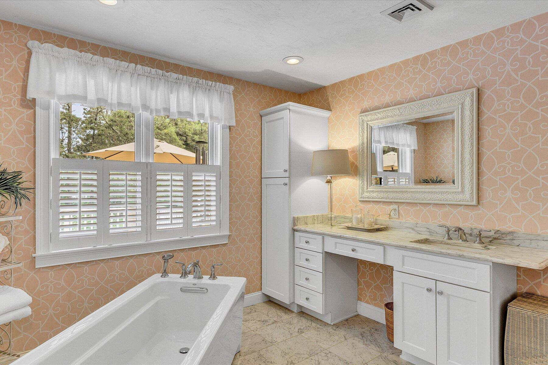 663 Crowells Bog Road Brewster, MA 02631 - Photo 18 of 46 a bathroom with a granite countertop sink mirror and a bathtub