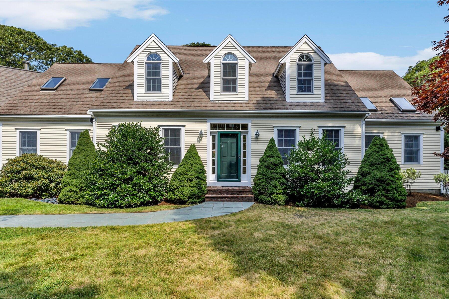 663 Crowells Bog Road Brewster, MA 02631 - Photo 3 of 46 a view of a white house with a yard and plants