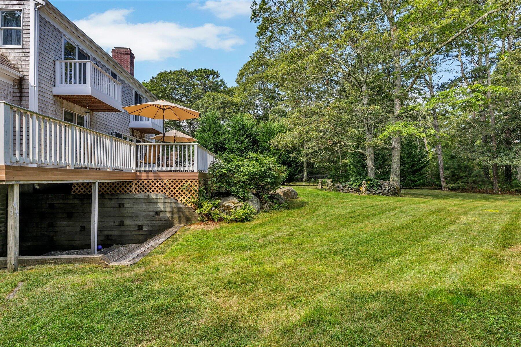 663 Crowells Bog Road Brewster, MA 02631 - Photo 33 of 46 a view of a house with a yard and sitting area