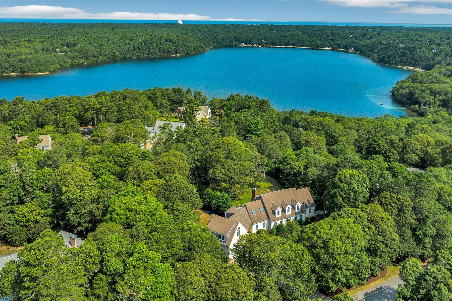 663 Crowells Bog Road Brewster, MA 02631 - Photo 40 of 46 an aerial view of a houses with outdoor space and a lake view