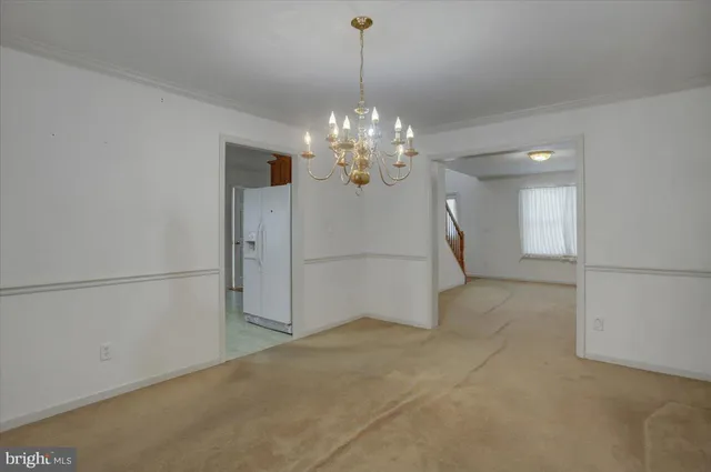 a large kitchen with stainless steel appliances granite countertop a sink and a refrigerator