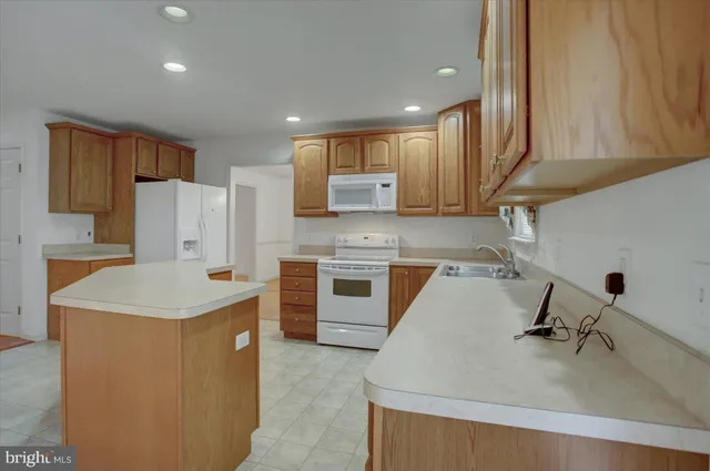 a kitchen with a sink cabinets and wooden floor