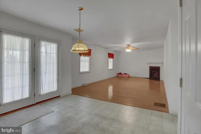 a view of empty room with wooden floor