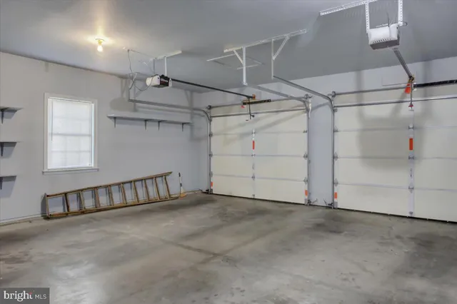 a view of a hallway with windows and chandelier