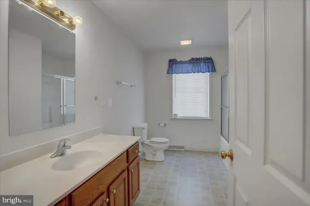 an empty room with chandelier fan