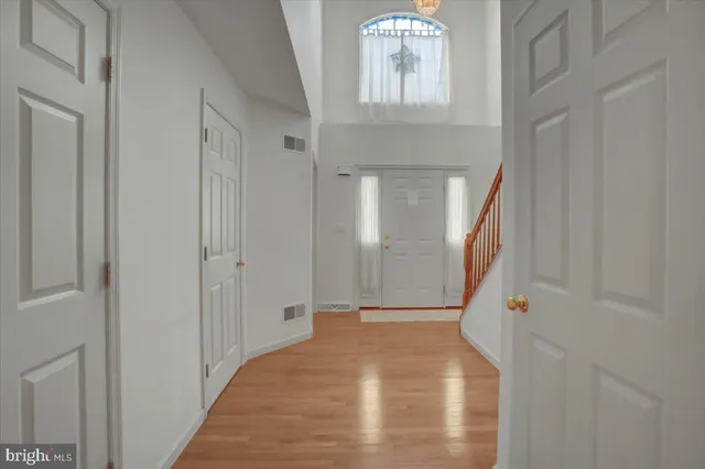 a view of staircase with wooden floor and white walls