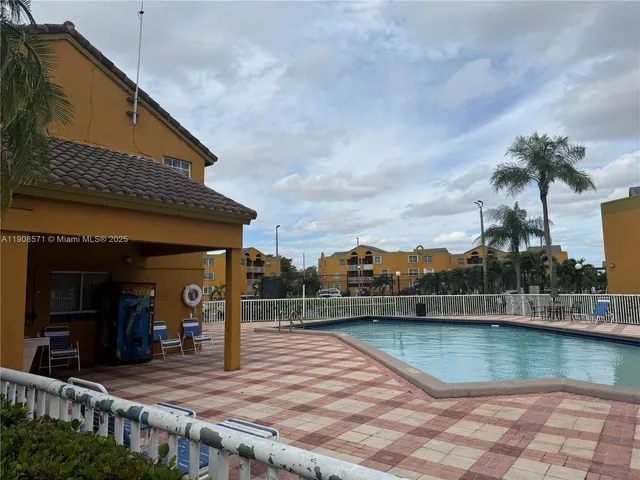 a view of a house with swimming pool and sitting area