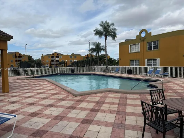 a view of swimming pool with a lounge chairs