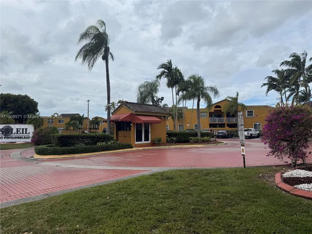a front view of a house with yard and garage