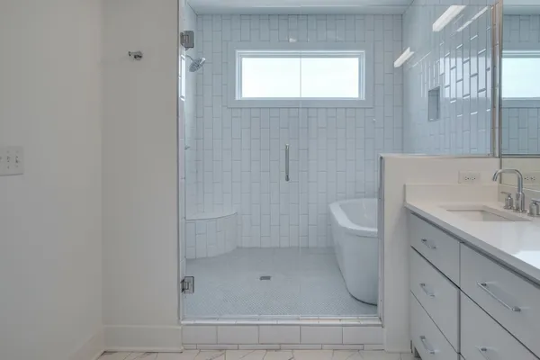 a bathroom with a bath tub with a shower