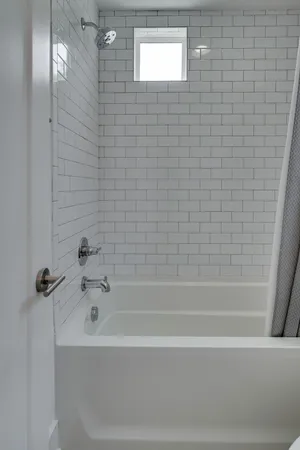 a front view of a house with a yard and green space