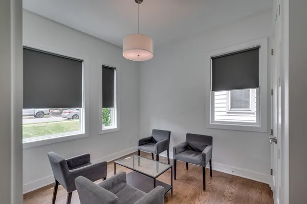 a dining room with wooden floor and a window