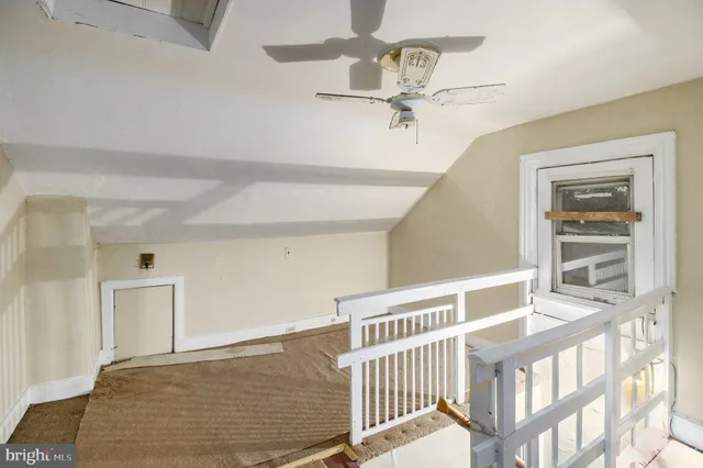 a view of a livingroom with a ceiling fan and wooden floor