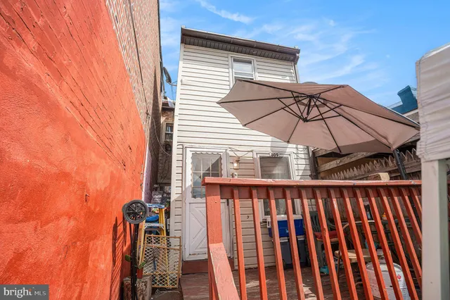 a blue and white umbrella sitting in front of a door
