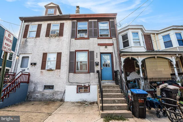 a front view of a building with outdoor seating