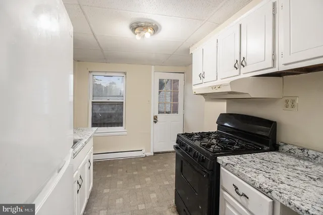 a kitchen with a stove and a refrigerator