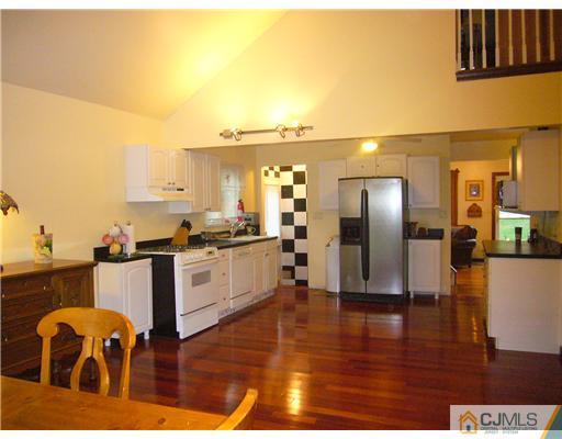 15 Channing Road East Brunswick, NJ 08816 - Photo 4 of 10 a kitchen with stainless steel appliances granite countertop a refrigerator and a stove top oven