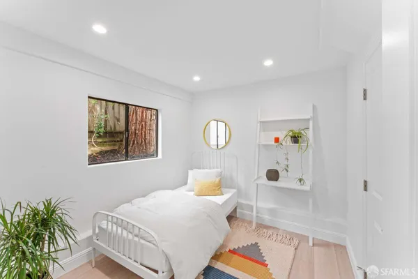 a bedroom with a bed and window