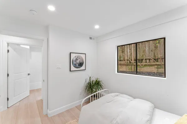 a bedroom with a bed and a painting on the wall