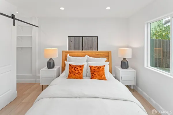 a bedroom with a bed and window