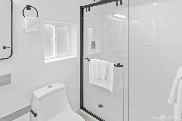 a bathroom with a shower and toilet