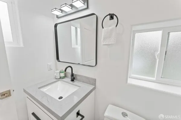 a bathroom with a sink vanity and mirror