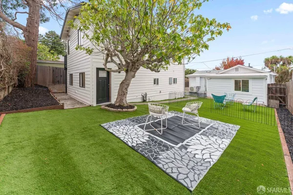 a view of a house with a yard porch and sitting area