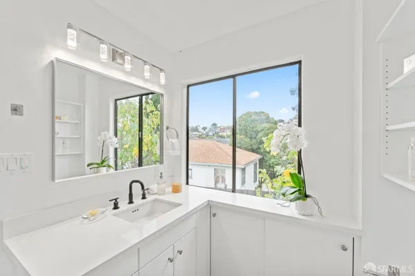 a bathroom with a sink and a window