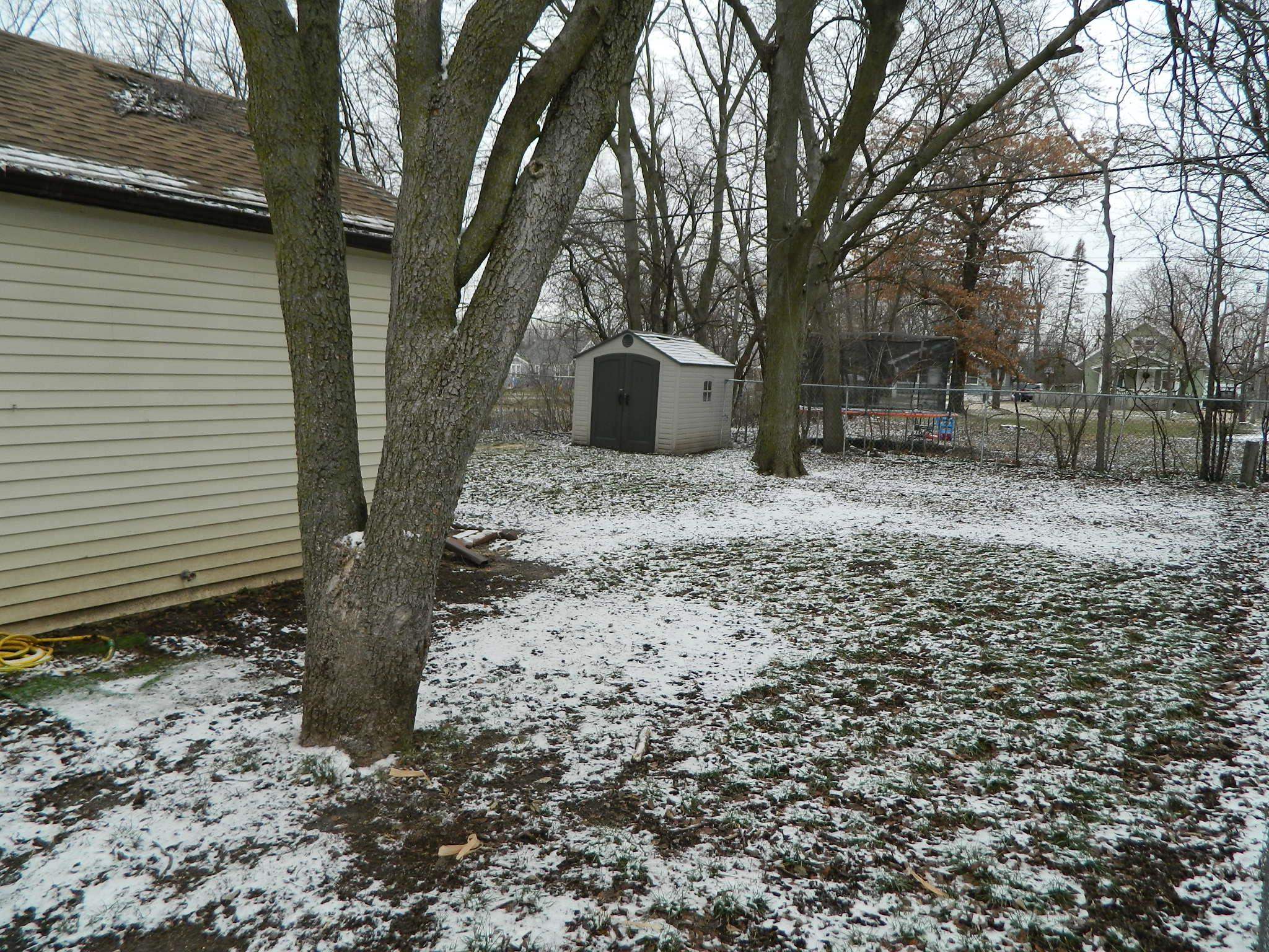504 Fitch Road Rockford, IL 61109 - Photo 5 of 15 a yellow house with trees in front of it