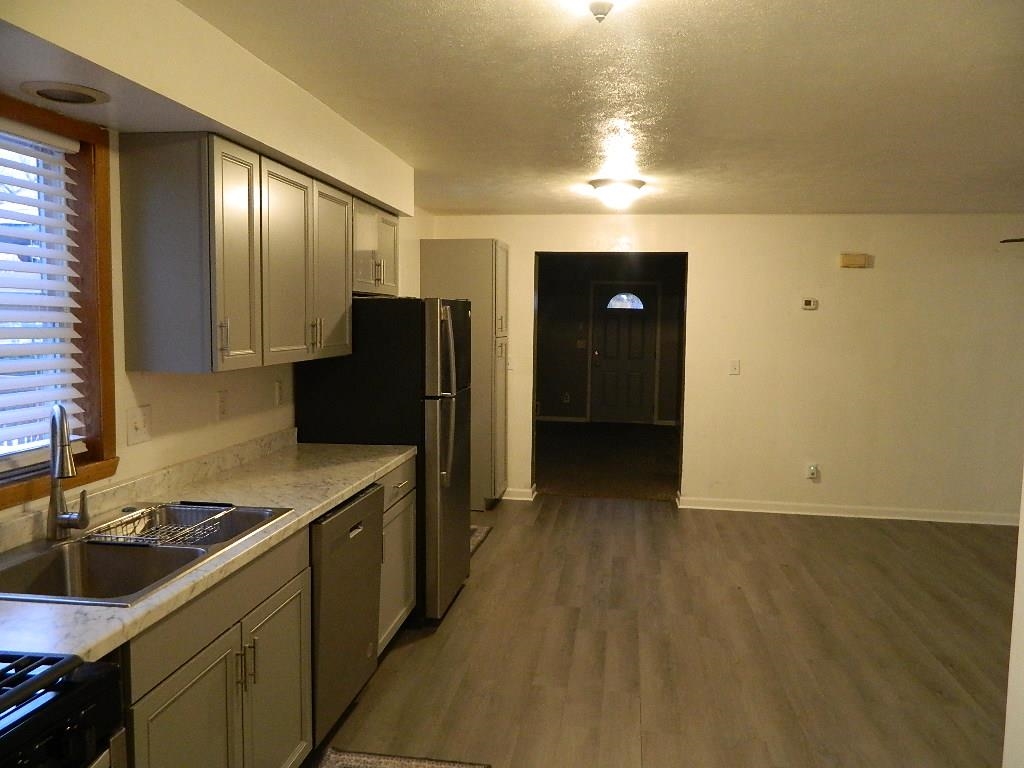 504 Fitch Road Rockford, IL 61109 - Photo 6 of 15 a kitchen with a sink and a refrigerator