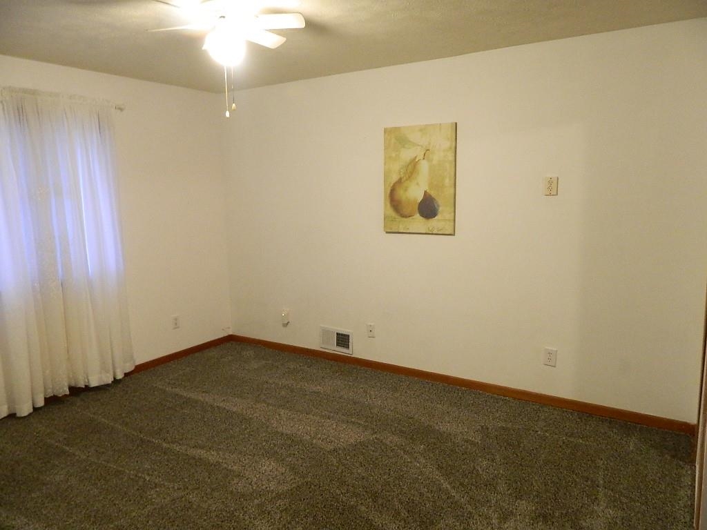 504 Fitch Road Rockford, IL 61109 - Photo 8 of 15 an empty room with a chandelier fan