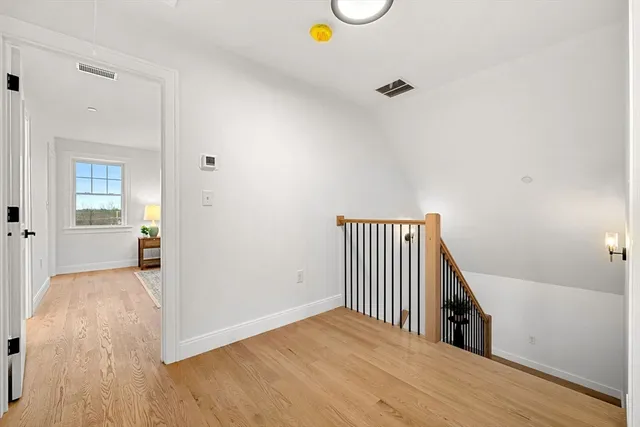 a view of a room with wooden floor and bathroom
