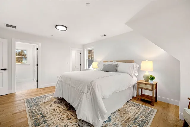 a bedroom with a bed and a rug