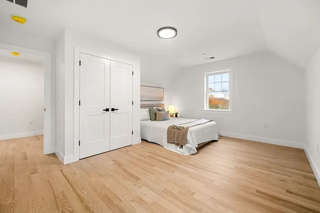 a spacious bedroom with a bed and a window