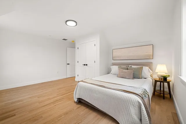 a bedroom with a bed and a lamp