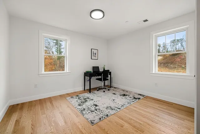 a view of a room with wooden floor and a window