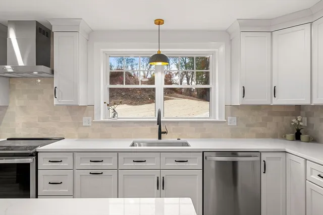 a kitchen with granite countertop a sink cabinets and window