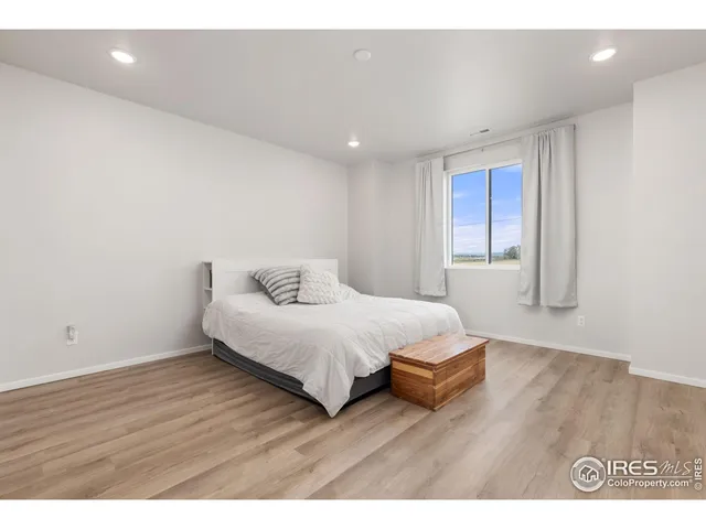 a bedroom with a bed and a night stand