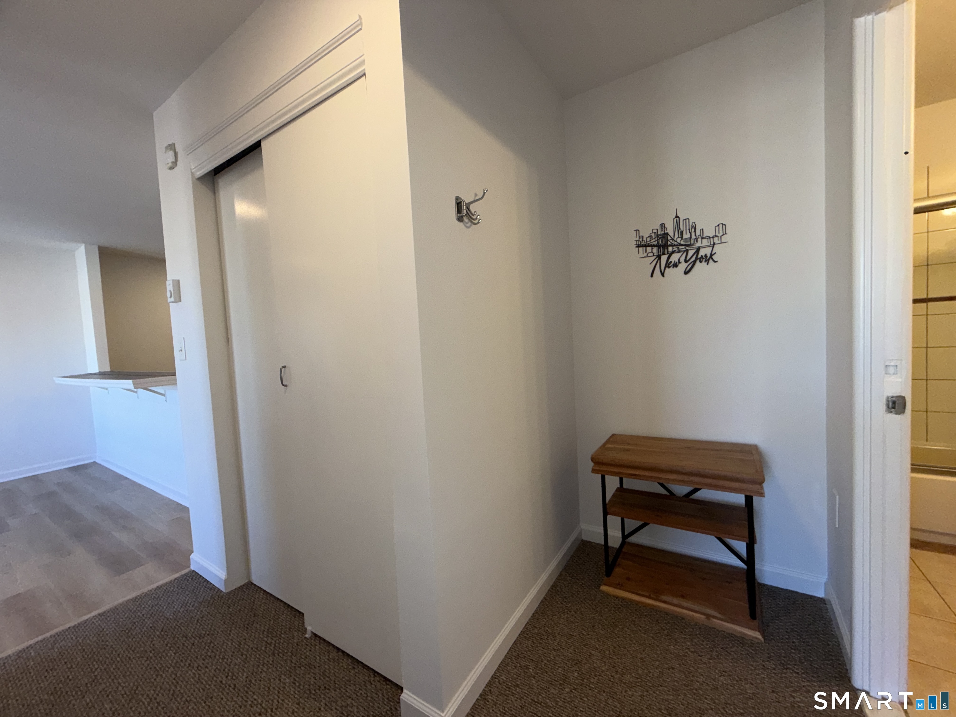 69 Cove Road, Unit B9 Stamford, CT 06902 - Photo 11 of 17 Outside bathroom and hallway, a nook for tucking away quick items