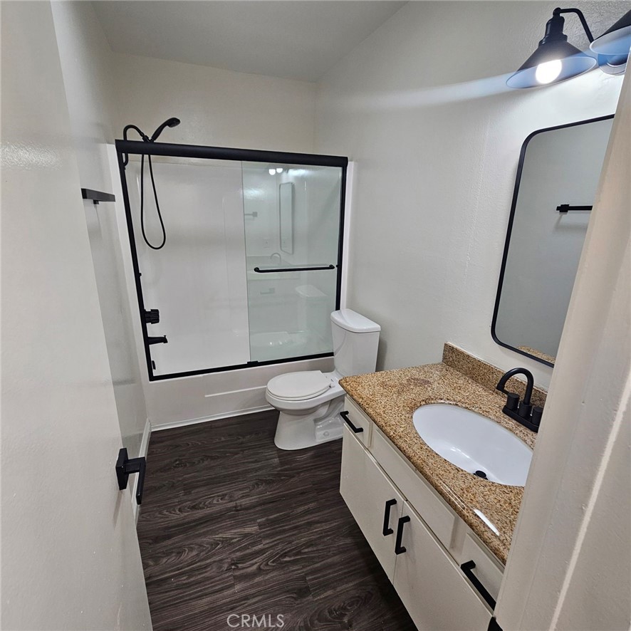 209 South Prospect Avenue, Unit 110 Redondo Beach, CA 90277 - Photo 4 of 11 a bathroom with a granite countertop sink toilet and shower