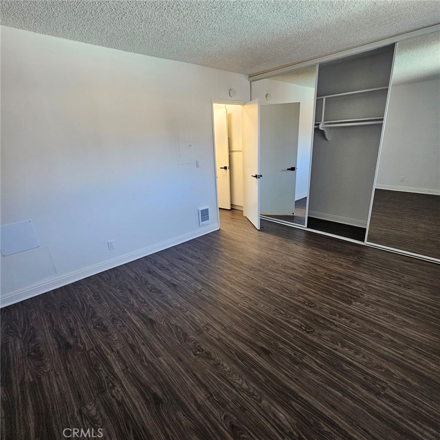 209 South Prospect Avenue, Unit 110 Redondo Beach, CA 90277 - Photo 5 of 11 a view of an empty room with wooden floor and a window