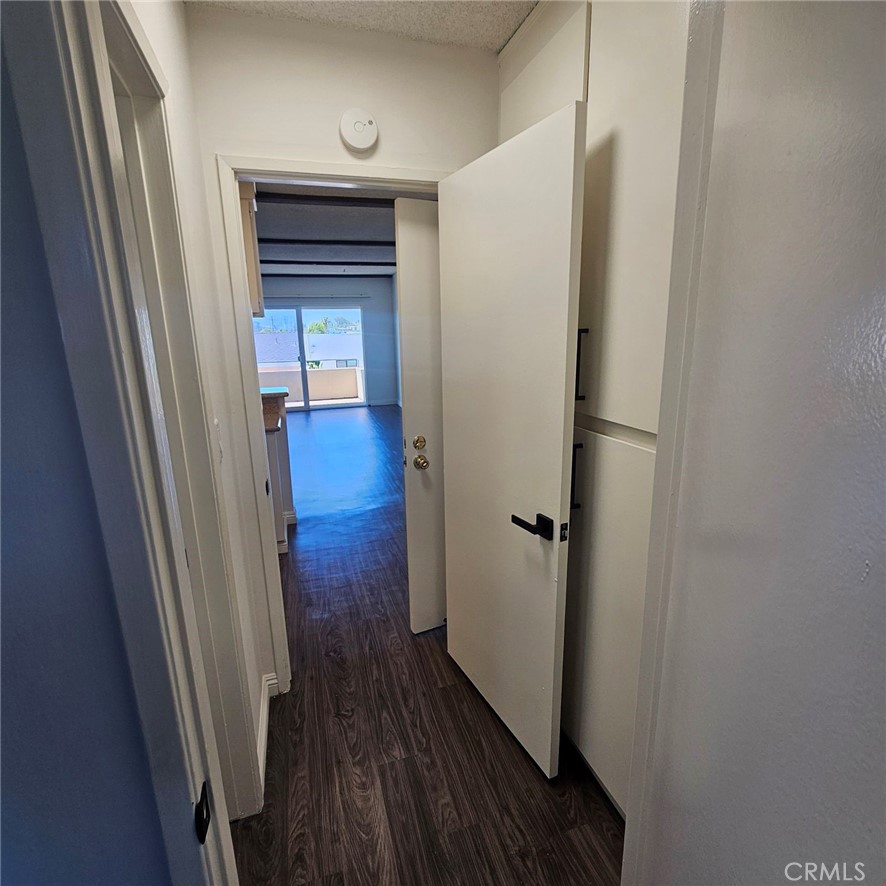 209 South Prospect Avenue, Unit 110 Redondo Beach, CA 90277 - Photo 6 of 11 a view of a hallway with wooden floor and staircase